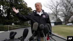 President Donald Trump talks with reporters outside the White House before traveling to Alabama to visit areas affected by the deadly tornadoes, March 8, 2019, in Washington.