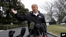 President Donald Trump talks with reporters outside the White House, March 8, 2019, in Washington.