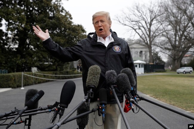 President Donald Trump talks with reporters outside the White House before traveling to Alabama to visit areas affected by the deadly tornadoes, March 8, 2019.