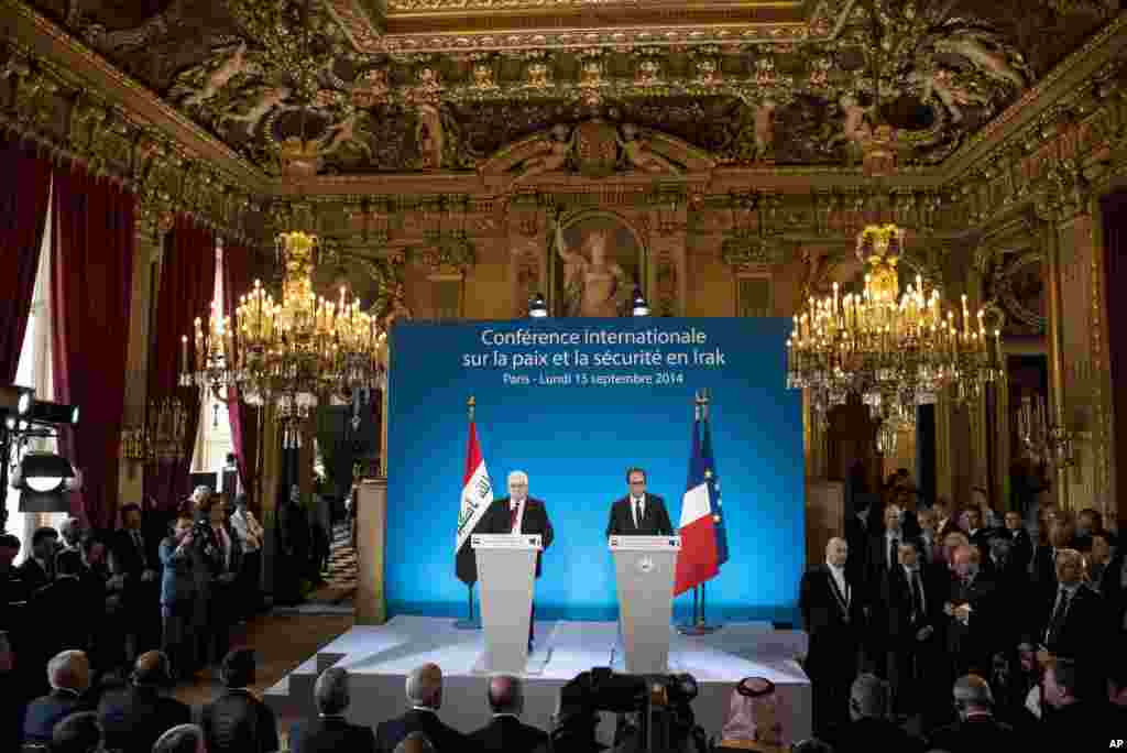 French President Francois Hollande (right) and his Iraqi counterpart, Fouad Massoum, attend the opening of an international conference intended to establish an international strategy against the Islamic State militants, in Paris, Sept. 15, 2014.