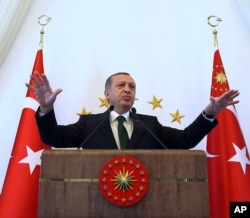 Turkish President Recep Tayyip Erdogan addresses people from southeastern Turkey, in Ankara, Turkey, Tuesday, Oct. 20, 2015.