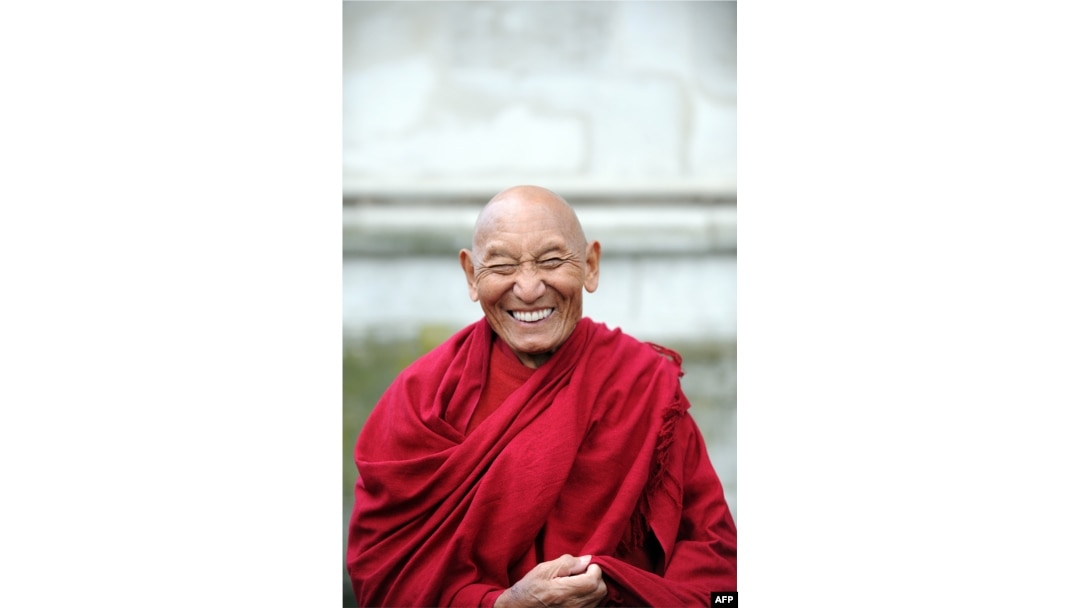 FILE - Tibetan Buddhist monk Palden Gyatso attends a wreath-laying ceremony at the Memorial to Innocent Victims, outside Westminster Abbey in London, March 10, 2009.