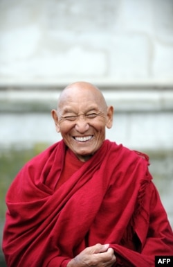 FILE - Tibetan Buddhist monk Palden Gyatso attends a wreath-laying ceremony at the Memorial to Innocent Victims, outside Westminster Abbey in London, March 10, 2009.