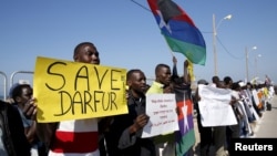 Demonstrators, most from Sudan and its Darfur region, hold placards as they protest in front of the American Embassy in Tel Aviv against human rights violations, Feb. 3, 2016.