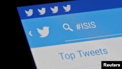 FILE - The Islamic State hashtag (#ISIS) is seen typed into the Twitter application on a smartphone in this picture illustration taken in Zenica, Bosnia and Herzegovina.