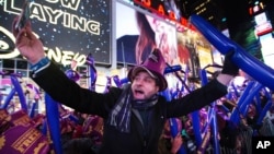 A reveler takes a photo of himself during the annual New Year's Eve celebration in Times Square on Thursday, Dec. 31, 2015.
