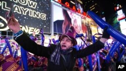 A reveler takes a photo of himself during the annual New Year's Eve celebration in Times Square on Thursday, Dec. 31, 2015.