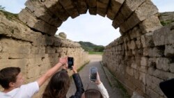 School students use a mobile app at the ancient site of Olympia, southwestern Greece, Wednesday, Nov. 10, 2021. (AP Photo/Thanassis Stavrakis)