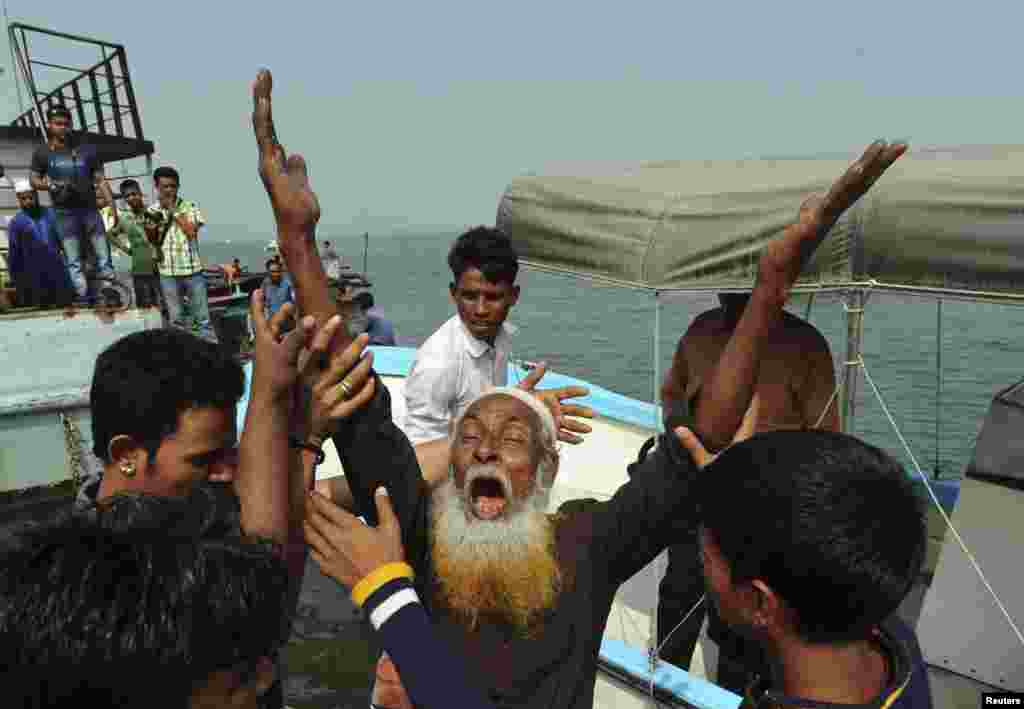 A relative of a missing passenger mourns after a ferry sank on the Meghna river, in Munshiganj, Bangladesh, Feb. 8, 2013.