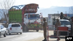 FILE - Pakistani army soldiers stand guard at a checkpoint in in North Waziristan, near the border between Pakistan and Afghanistan, Jan. 27, 2019. A skirmish at a similar checkpoint killed three people Sunday.