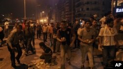 Coptic protesters gather rocks during clashes with Egyptian security forces at a protest of a recent attack on a church in Cairo Egypt, Sunday, Oct. 9, 2011.