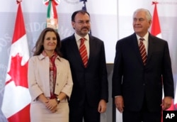 Canada's Minister of Foreign Affairs Chrystia Freeland, from left, Mexican Foreign Minister Luis Videgaray, and U.S. Secretary of State Rex Tillerson, pose for a group photo at the end of their joint press conference in Mexico City, Feb. 2, 2018.