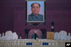 A Chinese paramilitary policeman stands guard in front of Mao Zedong's portrait on Tiananmen Gate on the 30th anniversary of a bloody crackdown of pro-democracy protesters in Beijing on Tuesday, June 4, 2019.