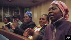 Zimbabwean women at a church in Johannesburg clap, sing and pray for better days