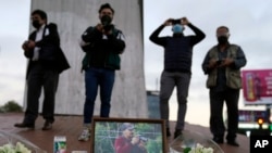 Journalists cover a vigil in honor of news photographer Margarito Martinez, pictured, Friday, Jan. 21, 2022, in Tijuana, Mexico.