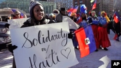 FILE - In this Jan. 26, 2018 file photo, Haitian activists and immigrants protest on City Hall Plaza in Boston over the Trump administration's move to cut off permission for thousands of Haitians to live in the U.S. through the TPS program.
