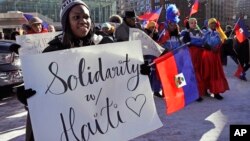 FILE - Haitian activists and immigrants protest on City Hall Plaza in Boston, Jan. 26, 2018.