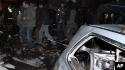 Lebanese security forces at the site of a car bomb that blew up near a gas station, at a stronghold of Lebanon's militant Hezbollah group, in Hermel, northeast Lebanon, Feb. 1, 2014.