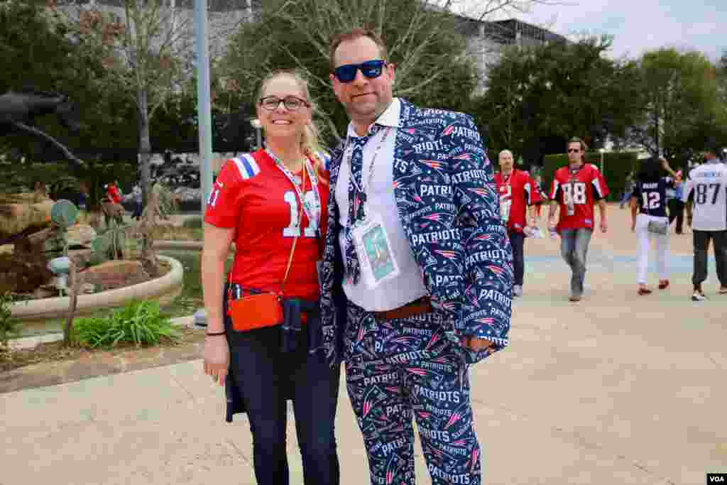 Para penonton Super Bowl memakai warna tim kegemaran mereka dengan berbagai cara; ada yang memakai kaos seragam, ada yang memakai setelan jas khusus bergambar logo tim mereka. (VOA/B. Allen)