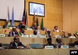 This photo taken Dec. 21, 2017, shows African Union chairman Moussa Faki, 2nd left-top, sitting with members of the Intergovernmental Authority for Development (IGAD) as they attend a signing ceremony for the cease-fire agreement amongst South Sudanese parties to end the war in the country, at the headquarters of African Union in the Ethiopian capital, Addis Ababa.