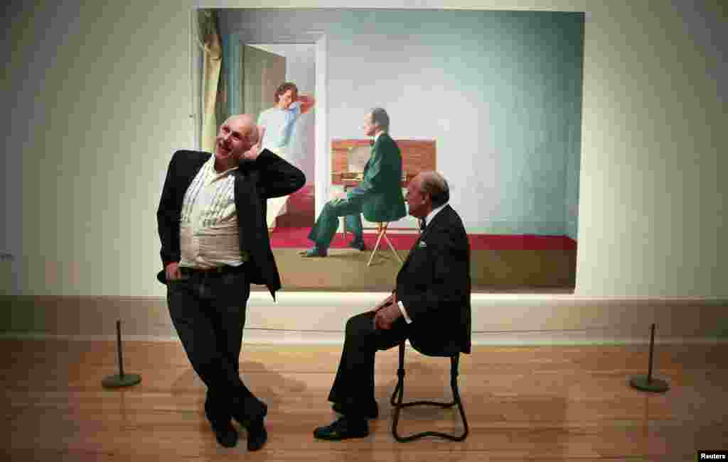 Ballet dancer Wayne Sleep (L) and book dealer George Lawson pose in front of "George Lawson and Wayne Sleep" by David Hockney at Tate Britain in London, Britain.