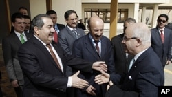 Iraqi Foreign Minister Hoshyar Zebari, left, welcomes Algeria's Foreign Minister Mourad Medelci, right, in Baghdad, Iraq, March 27, 2012.