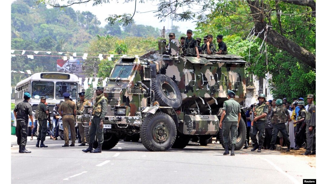 Sri Lanka's army soldiers stand guard a road after a clash between two communities in Digana, central district of Kandy, Sri Lanka, March 6, 2018.