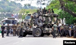 Sri Lanka's army soldiers stand guard a road after a clash between two communities in Digana, central district of Kandy, Sri Lanka, March 6, 2018.