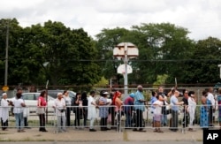 People stand in a line stretching for blocks outside New Bethel Baptist Church to pay their respects to legendary singer Aretha Franklin, Aug. 30, 2018, in Detroit. Franklin died Aug. 16, 2018.