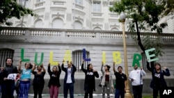 People hold letters reading in Spanish "Free Lula" as they protest outside the Brazilian embassy against the detention of former Brazilian President Luiz Inacio Lula da Silva, in Buenos Aires, Argentina, April 6, 2018.