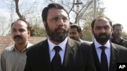 Asad Manzoor Butt (C) and Numan Attique (R), lawyers for the families of the two men killed by U.S. contractor Raymond Davis, walk together with the victim's brother, Imran Haider (L), after attending Davis' hearing in Lahore, March 8, 2011