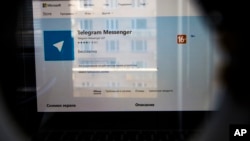 The website of the Telegram messaging app is seen on a computer's screen in Moscow, Russia, Friday, April 13, 2018. A Russian court has ordered the blocking of a popular messaging app following a demand by authorities that it share encryption data with them. (AP Photo/Alexander Zemlianichenko)