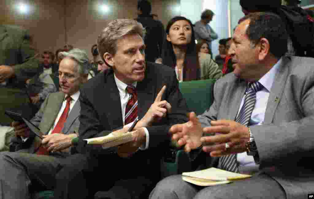 U.S. envoy Chris Stevens, center, accompanied by British envoy Christopher Prentice, left, speaks to Council member for Misrata Dr. Suleiman Fortia, right, at the Tibesty Hotel where an African Union delegation was meeting with opposition leaders in Benghazi.