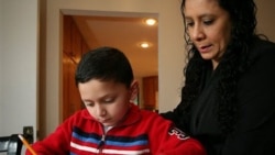 Ashton Faller doing homework with his mother last year. Ashton has received treatment for autism since he was 2 years old