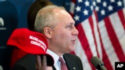 FILE - House Majority Whip Steve Scalise of Louisiana displays a "Make America Great Again" hat while speaking with reporters on Capitol Hill in Washington after a House Republican leadership meeting, Nov. 15, 2016. Donald Trump 2016 presidential campaign owns the phrase.