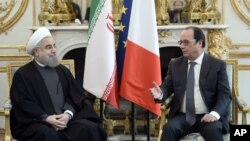 Presiden Iran Hassan Rouhani (kiri) dan Presiden Perancis Francois Hollande dalam pertemuan di istana Elysee di Paris, Kamis (28/1).