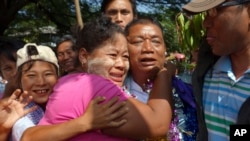 Political prisoner Win Shwe, center, is welcomed by family members after he was released from Insein Prison in Rangoon, Burma, Dec. 31, 2013