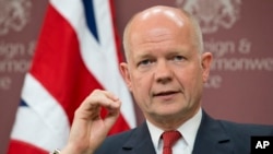 FILE - Britain's Foreign Secretary William Hague speaks during his press conference after the "Friends of Syria Meeting" at the Foreign Office in London.