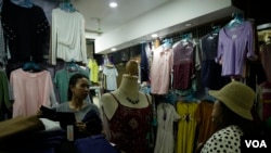 Soung Pisey at here clothes store in Takmao market, Kandal province, Cambodia, October 2017. (Khan Sokumnono/VOA Khmer)