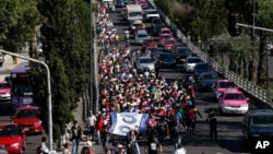 A group of Central American migrants, some of the thousands participating in caravans trying to reach the U.S. border, undertake an hours-long march to the office of the U.N. human rights body in Mexico City, Nov. 8, 2018.