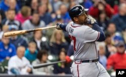 Atlanta Braves' Matt Kemp connects for an RBI-single off of Milwaukee Brewers' Matt Garza during the first inning of a baseball game, April 30, 2017, in Milwaukee.