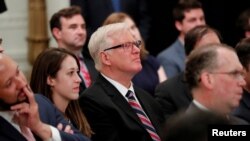 FILE - Gateway Pundit publisher Jim Hoft listens as U.S. President Donald Trump speaks during a "social media summit" meeting with prominent conservative social media figures in the East Room of the White House in Washington, July 11, 2019. 