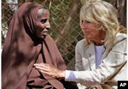 FILE _ Jill Biden, wife of then-U.S. Vice President Joe Biden, center, sits with Somali refugees at a UNHCR screening center on the outskirts of Ifo camp outside Dadaab, eastern Kenya, 100 kms (60 miles) from the Somali border, Aug. 8, 2011.