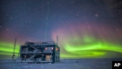 This undated photo provided by NOAA in May 2018 shows aurora australis near the South Pole Atmospheric Research Observatory in Antarctica. 