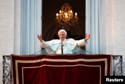 Pope Benedict waves to the faithful from the balcony of his summer residence in Castel Gandolfo, Feb. 28, 2013.