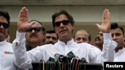FILE - Cricket star-turned-politician Imran Khan, chairman of Pakistan Tehreek-e-Insaf (PTI), speaks after voting in the general election in Islamabad, July 25, 2018. 