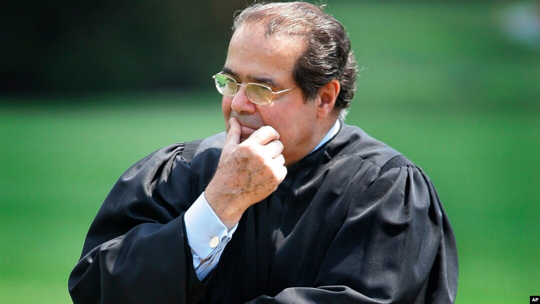 FILE - In this 2006 photo, Supreme Court Justice Antonin Scalia listens to President Bush speak during a ceremony at the White House.