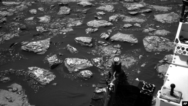 This Dec. 2, 2016 image taken by NASA's Curiosity rover shows rocky ground on the lower flank of Mount Sharp, a mountain on Mars. Curiosity landed on the red planet in 2012 and uncovered geologic evidence of an ancient environment.