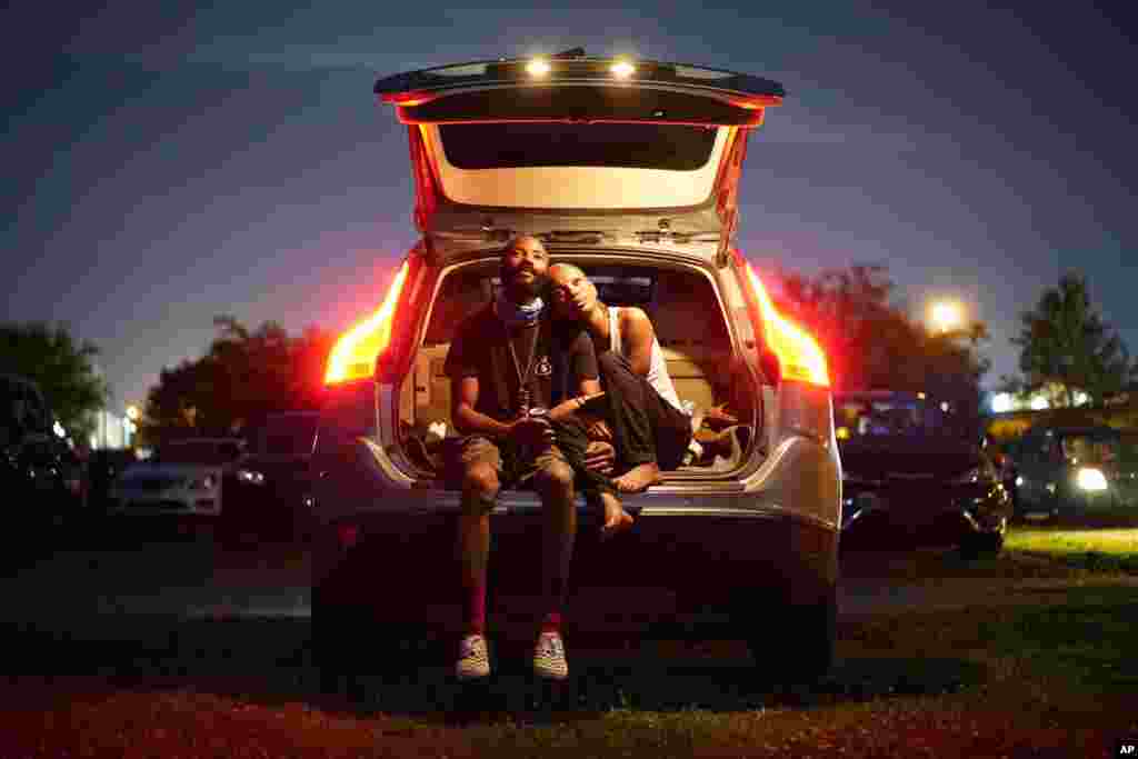 Kene Daniels, right, and Amman Raheem watch a documentary called &quot;Rebuilding Black Wall Street,&quot; during a drive-in screening of documentaries during centennial commemorations of the Tulsa Race Massacre, May 26, 2021, in Tulsa, Oklahoma.