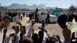 People wave to Pope Francis as he arrives to celebrate Mass in San Cristobal de las Casas, Mexico, Feb. 15, 2016.